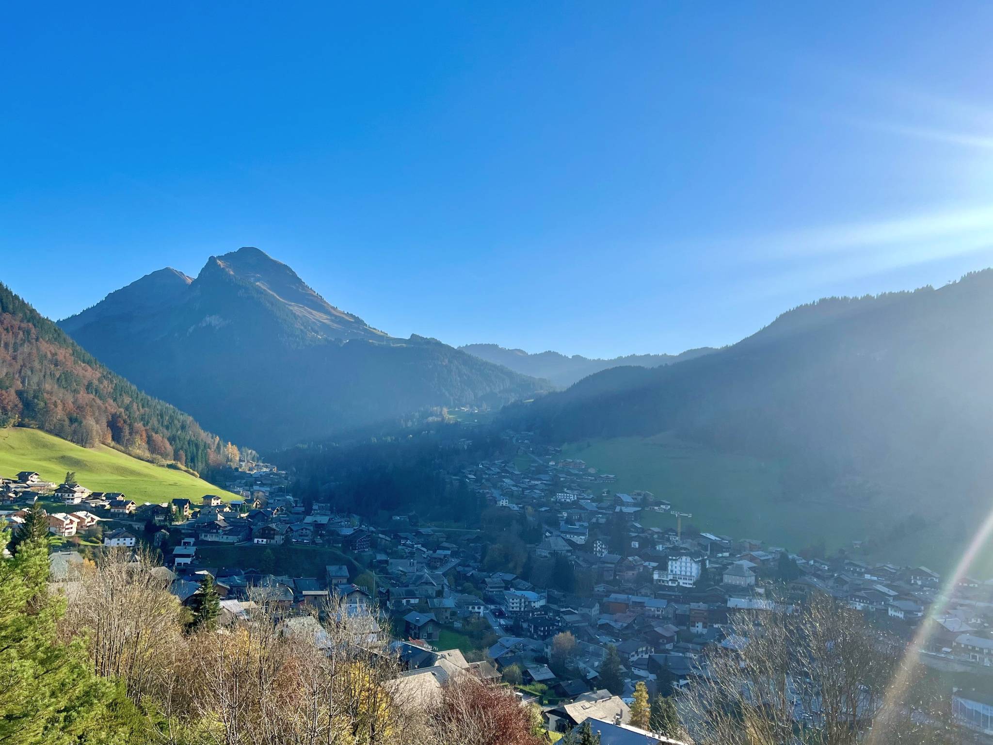 Morzine winter sunlight south-facing slope in sun while village center is in shadow